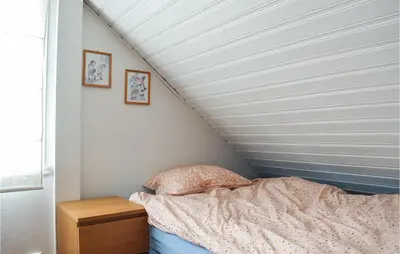 a bedroom with a bed and a white ceiling at Lovely Home In Valevåg With Wifi in Valevåg