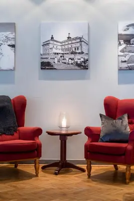 a living room with two chairs and a table at Oppdal Turisthotell in Oppdal