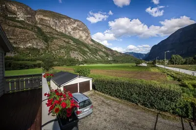 a car parked on a balcony with mountains in the background at Apartment AliS in Tønjum