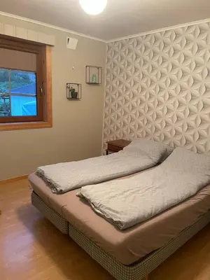 a bedroom with two beds and a window at Apartment AliS in Tønjum