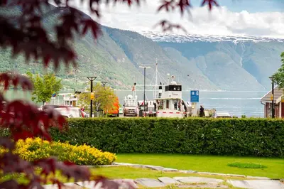 a boat is docked next to a body of water at Walaker Hotel in Solvorn