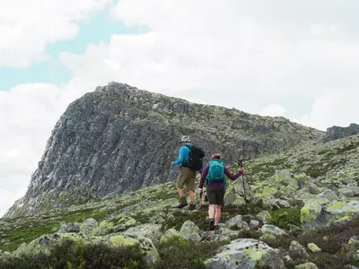 two people walking up a rocky mountain at Gaustablikk Fjellresort in Gaustablikk