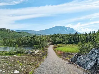 a dirt road with a mountain in the background at Gaustablikk Fjellresort in Gaustablikk