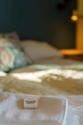 a piece of paper sitting on top of a bed at Grønolen Fjellgard in Beitostøl