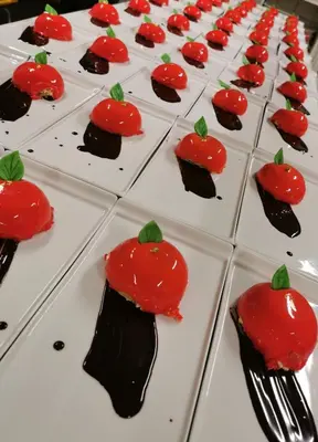 a row of red and black cookies with a strawberry on them at Grønolen Fjellgard in Beitostøl