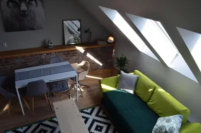 a living room with a green couch and a table at MB Apartments in Bergen
