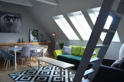 a living room with a green couch and a table at MB Apartments in Bergen