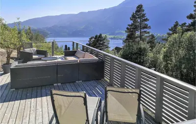 a patio with two chairs and a couch on a deck at Stunning Home In Hebnes With Kitchen in Hebnes