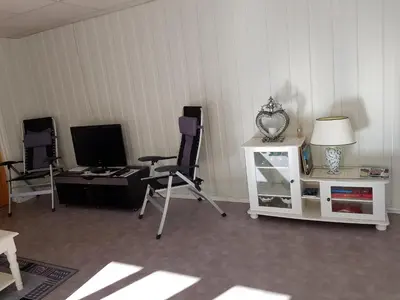 a room with two chairs and a television and a table at Leilighet i Åmotsdal in Åmotsdal