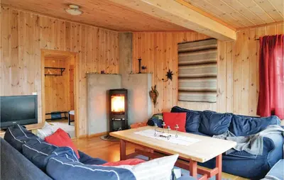 a living room with a blue couch and a table at Sjusjøen Pihl 185 in Sjusjøen