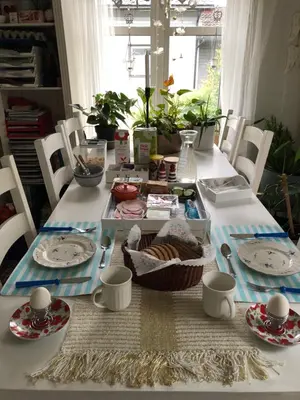 a table with plates and a basket of food on it at Bed and breakfast in Sauda