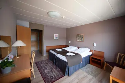 a hotel room with a bed and a desk at Strand Fjordhotel in Ulvik