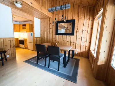a dining room with a table and chairs in a cabin at Blåtind Apartments in Stordal