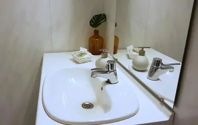 a bathroom with a white sink and a mirror at Blåtind Apartments in Stordal