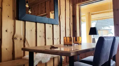 a wooden table in a room with a window at Blåtind Apartments in Stordal