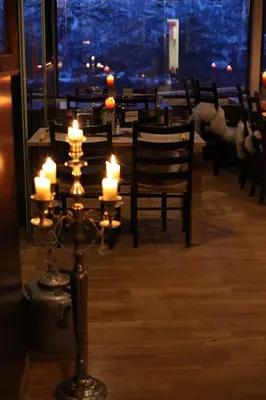 a room with a table with candles in a restaurant at Hordatun Hotel in Røldal