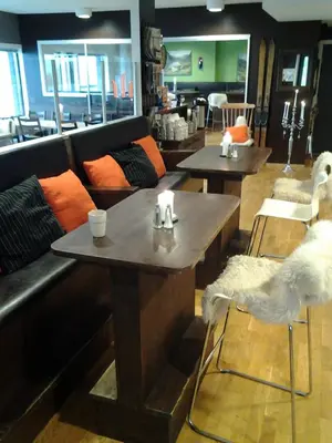a living room with a couch and two tables at Hordatun Hotel in Røldal