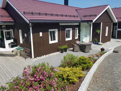 a house with a patio with chairs and a table at Family Room in Modern House in Eide