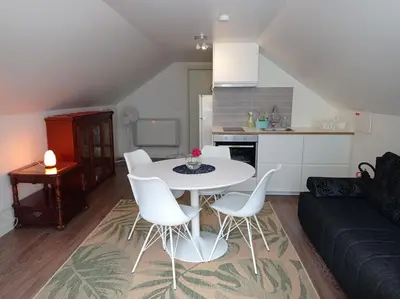 a living room with a white table and white chairs at Family Room in Modern House in Eide