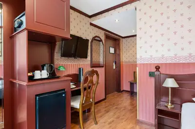 a kitchen with a table and a dining room at Best Western Laegreid Hotell in Sogndal