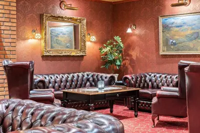 a waiting room with leather couches and a table at Best Western Laegreid Hotell in Sogndal