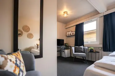 a mirror in a hotel room with a bedroom at Ågotnes Motell in Ågotnes