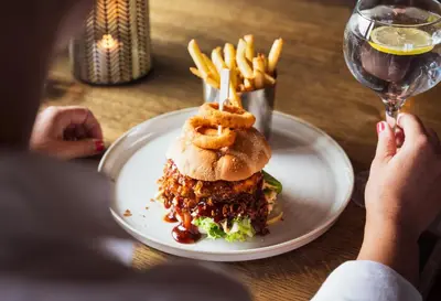 a plate of food with a sandwich and french fries at Ågotnes Motell in Ågotnes