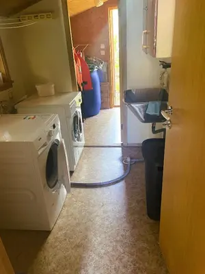 a kitchen with a washing machine in a room at Der Fjordtraum in Balestrand direkt am Wasser in Balestrand