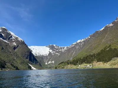 a view of a mountain lake with snow at Der Fjordtraum in Balestrand direkt am Wasser in Balestrand