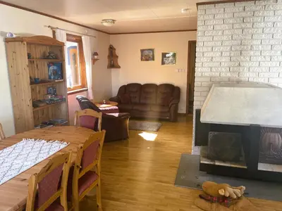 a living room with a couch and a fireplace at Der Fjordtraum in Balestrand direkt am Wasser in Balestrand
