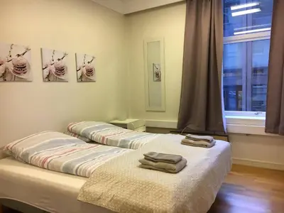 two beds sitting in a room with a window at Kirkegata 4 in Ålesund