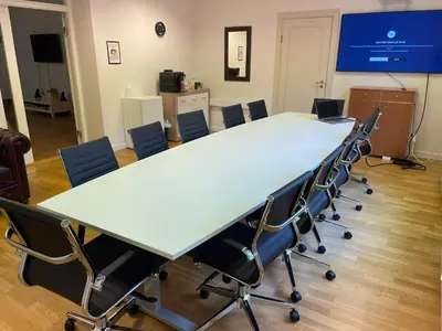 a conference room with a large table and chairs at Kirkegata 4 in Ålesund