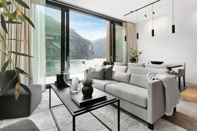 a living room with a couch and a table at Grande Fjord Hotel in Geiranger
