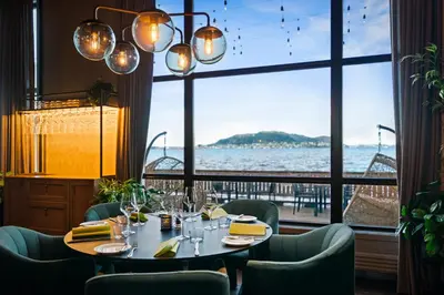 a dining room with a table and a large window at Quality Hotel Ålesund in Ålesund