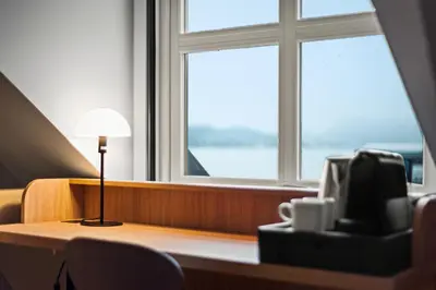 a lamp sitting on a desk in front of a window at Quality Hotel Ålesund in Ålesund