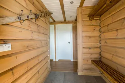 a room with wooden walls and a door at Gladheim in Stranda