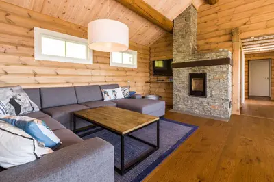 a living room with a couch and a fireplace at Gladheim in Stranda
