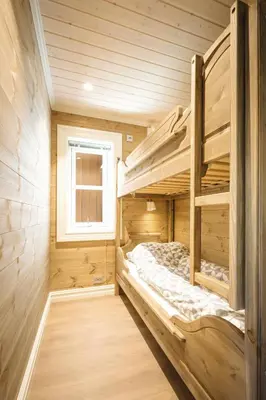 a bedroom with two bunk beds in a log cabin at Lastølen 3 bedrooms in Brunstad