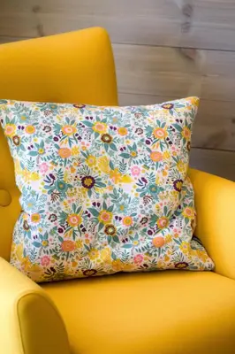 a pillow on a yellow chair with a flower pattern at Lastølen 3 bedrooms in Brunstad
