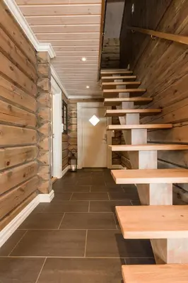 a hallway with wooden stairs in a house at Lake View Apartment 4 bedrooms in Brunstad