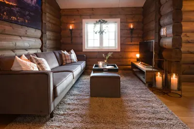 a living room with a couch and a television at Strandafjellet Mountain Lodge in Stranda
