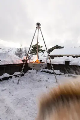 a swing in a yard covered in snow at Strandafjellet Mountain Lodge in Stranda
