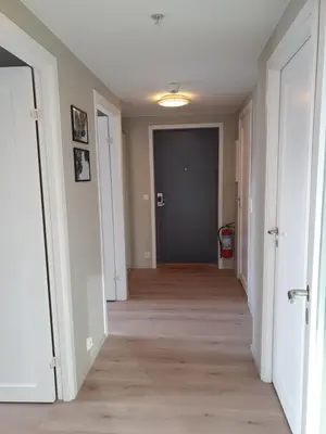 an empty hallway with a hallway leading to a door at Veversmauet Apartments in Bergen
