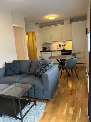 a living room with a couch and a table at Veversmauet Apartments in Bergen