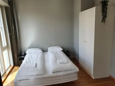 a bedroom with a white bed with two pillows at Veversmauet Apartments in Bergen