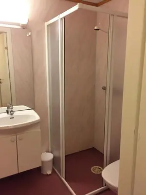 a bathroom with a shower and a sink at Moldefjord Hostel in Molde