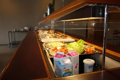 a buffet line with some food in a restaurant at Moldefjord Hostel in Molde