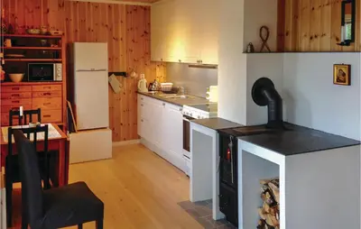 a kitchen with a white refrigerator and a counter top at Stunning Home In Seim With Wifi in Seim