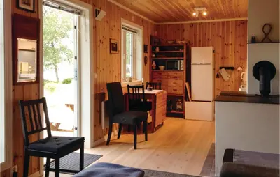 a kitchen with a table and chairs and a refrigerator at Stunning Home In Seim With Wifi in Seim