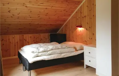 a bed in a room with a wooden ceiling at Stunning Home In Seim With Wifi in Seim